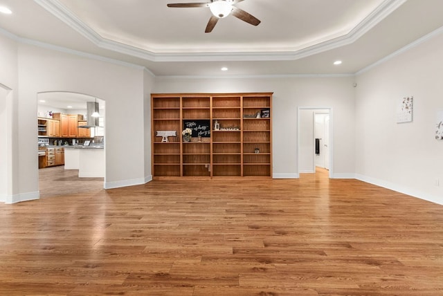 2800 Lomas Rodando Calzada Rd, Kempner, TX 76539 - unfurnished living room featuring a tray ceiling, a ceiling fan, recessed lighting, light wood finished floors, and arched walkways