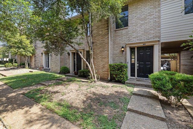 exterior space featuring brick siding