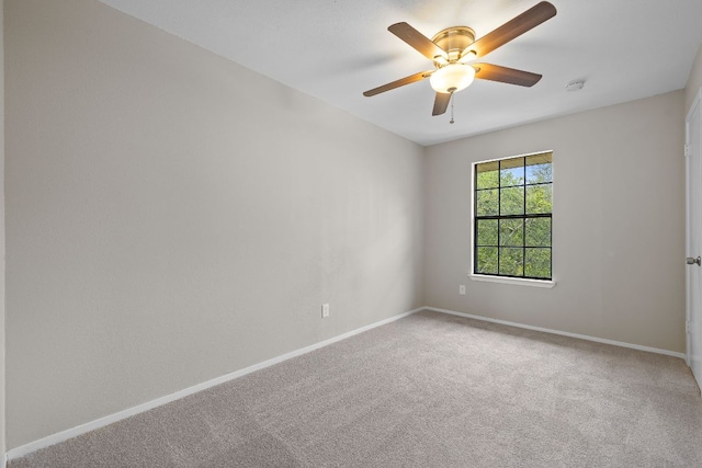 spare room with baseboards, a ceiling fan, and carpet flooring