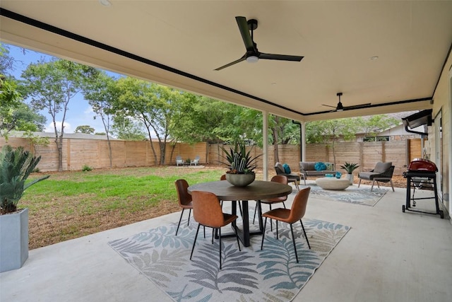 view of patio with a fenced backyard, a grill, a ceiling fan, outdoor dining space, and an outdoor living space