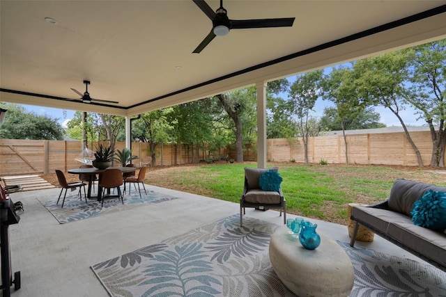 view of patio / terrace with a fenced backyard, an outdoor living space, a ceiling fan, and outdoor dining space