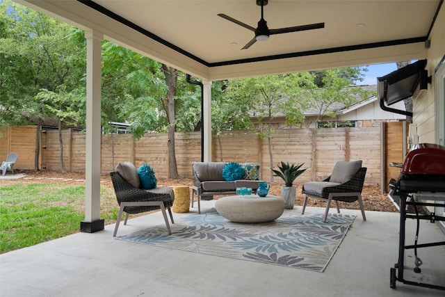 view of patio / terrace with a fenced backyard, a ceiling fan, area for grilling, and an outdoor hangout area