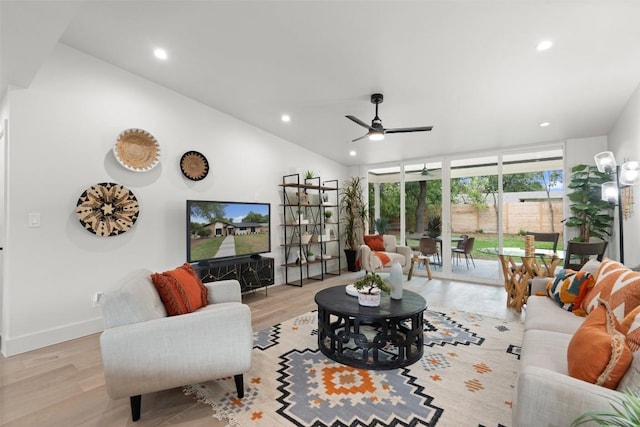 living room featuring vaulted ceiling, baseboards, recessed lighting, light wood-style floors, and a ceiling fan