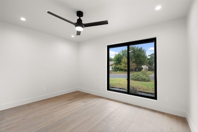 spare room featuring baseboards, a ceiling fan, light wood-style flooring, and recessed lighting
