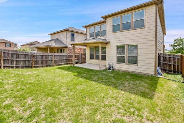 back of property featuring a yard, a patio area, and a fenced backyard