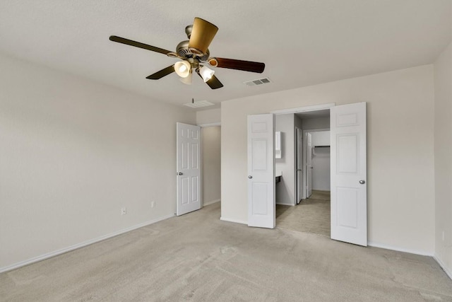 unfurnished bedroom featuring visible vents, baseboards, and light carpet