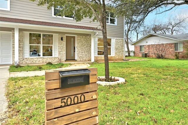 5000 Pack Saddle Pass, Austin, TX 78745 - exterior view of stone siding, a downspout, cooling unit, and gutters