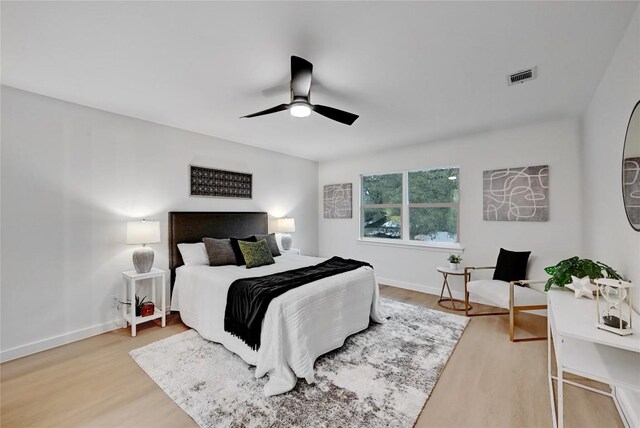 5000 Pack Saddle Pass, Austin, TX 78745 - bedroom with wood finished floors, a ceiling fan, and baseboards