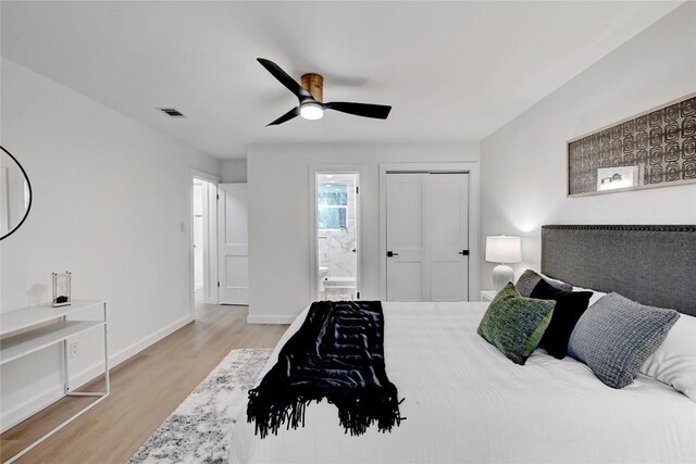 5000 Pack Saddle Pass, Austin, TX 78745 - bedroom with light wood-type flooring, ensuite bath, baseboards, ceiling fan, and a closet