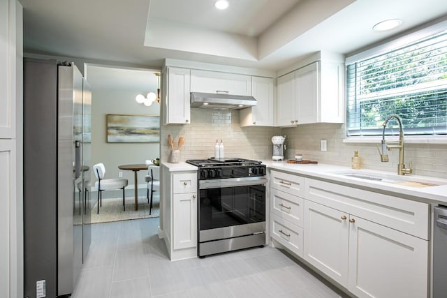 2011 Malvern Hill Dr, Austin, TX 78745 - kitchen featuring stainless steel appliances, a sink, under cabinet range hood, and light countertops