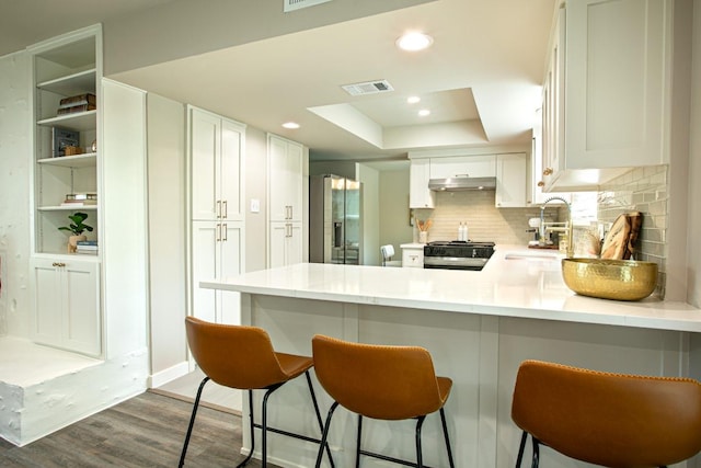 2011 Malvern Hill Dr, Austin, TX 78745 - kitchen featuring stainless steel fridge with ice dispenser, a sink, range, under cabinet range hood, and wood finished floors