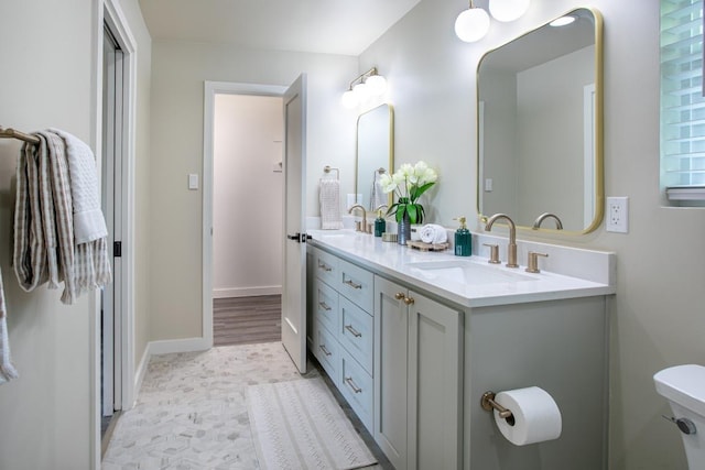 2011 Malvern Hill Dr, Austin, TX 78745 - bathroom with double vanity and baseboards