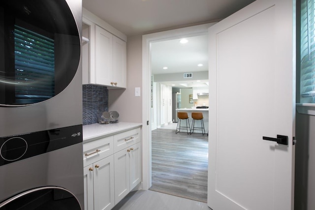 2011 Malvern Hill Dr, Austin, TX 78745 - laundry area with stacked washer / dryer, cabinet space, and recessed lighting