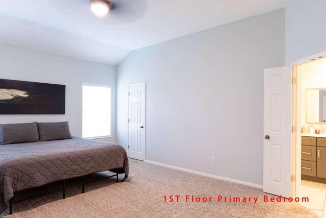 102 Buck Shot Ct, Bastrop, TX 78602 - bedroom with vaulted ceiling, light colored carpet, baseboards, and ensuite bathroom