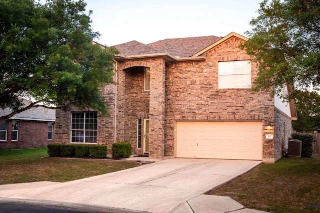 102 Buck Shot Ct, Bastrop, TX 78602 - view of front of home with driveway, a garage, a front lawn, and brick siding