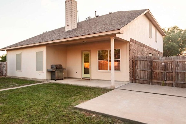 102 Buck Shot Ct, Bastrop, TX 78602 - rear view of property with a patio area, roof with shingles, and a chimney