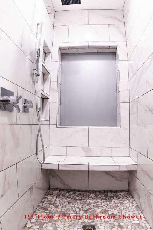 102 Buck Shot Ct, Bastrop, TX 78602 - full bath with a tile shower and tile walls