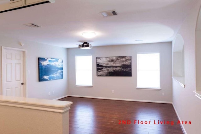 102 Buck Shot Ct, Bastrop, TX 78602 - unfurnished room featuring dark wood-type flooring, baseboards, and arched walkways