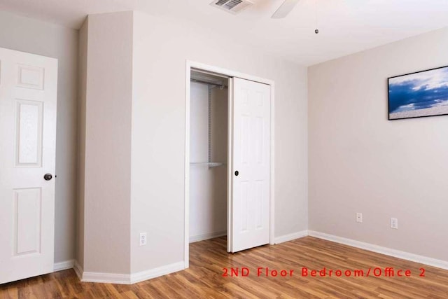 102 Buck Shot Ct, Bastrop, TX 78602 - unfurnished bedroom featuring wood finished floors, baseboards, and a closet