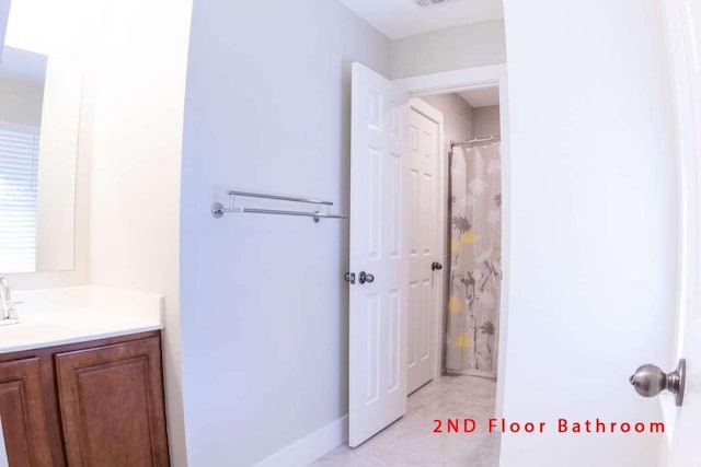 102 Buck Shot Ct, Bastrop, TX 78602 - bathroom with vanity, baseboards, and curtained shower