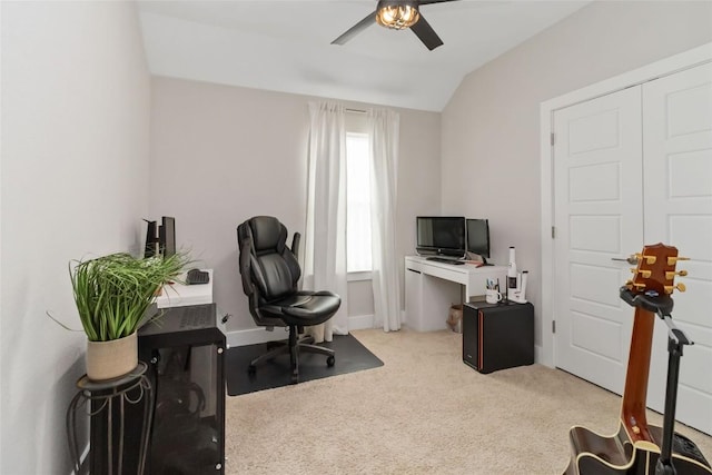 carpeted home office with vaulted ceiling, a ceiling fan, and baseboards