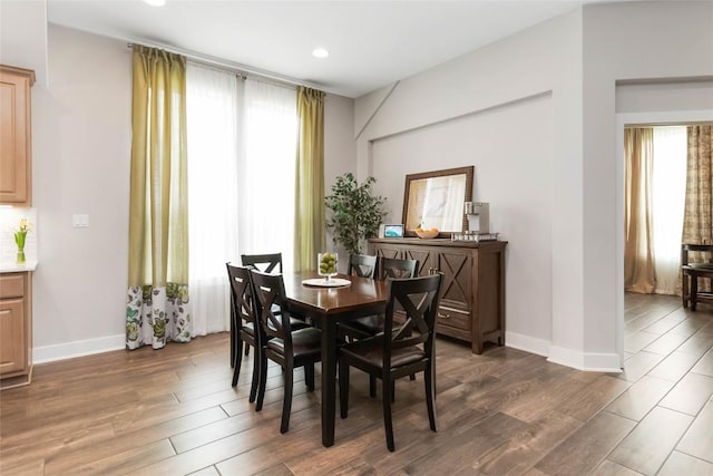 dining space with plenty of natural light, baseboards, and wood finished floors