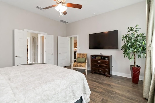 bedroom featuring dark wood finished floors, visible vents, baseboards, and ceiling fan