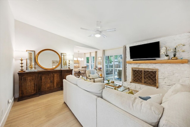 2602 Baxter Dr, Austin, TX 78745 - living room with lofted ceiling, wood finished floors, ceiling fan, a stone fireplace, and baseboards