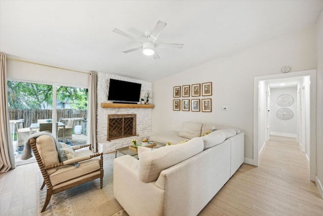 2602 Baxter Dr, Austin, TX 78745 - living room featuring ceiling fan, light wood-style floors, vaulted ceiling, a fireplace, and baseboards