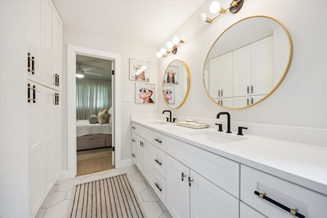2602 Baxter Dr, Austin, TX 78745 - ensuite bathroom featuring double vanity, baseboards, and tile patterned flooring