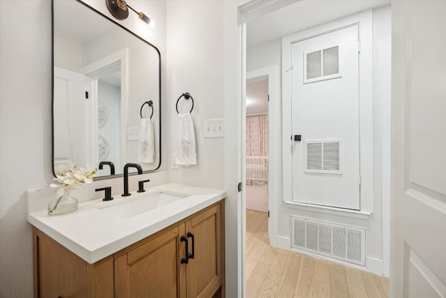 2602 Baxter Dr, Austin, TX 78745 - bathroom with vanity and wood finished floors