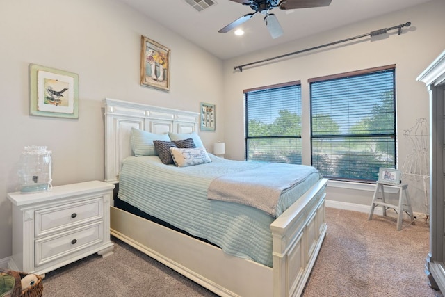 bedroom with visible vents, ceiling fan, baseboards, and light colored carpet