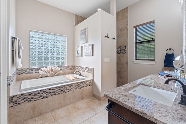bathroom featuring a tile shower, a garden tub, tile patterned flooring, and vanity