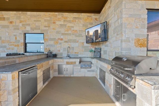 view of patio with grilling area, area for grilling, and a sink