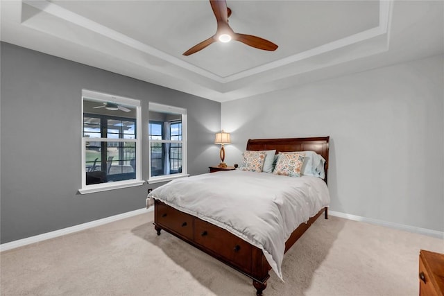 313 Brenham Pass, Georgetown, TX 78633 - bedroom featuring baseboards, a ceiling fan, a tray ceiling, and light colored carpet
