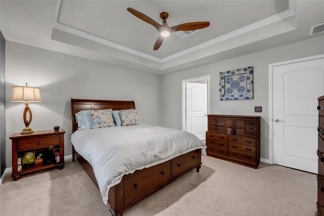 313 Brenham Pass, Georgetown, TX 78633 - bedroom featuring light carpet, a tray ceiling, and baseboards