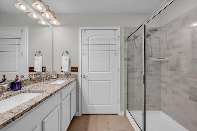 313 Brenham Pass, Georgetown, TX 78633 - bathroom featuring tile patterned flooring, a sink, and a stall shower