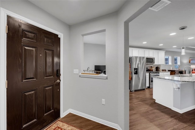 313 Brenham Pass, Georgetown, TX 78633 - entryway featuring baseboards, visible vents, recessed lighting, and dark wood-type flooring