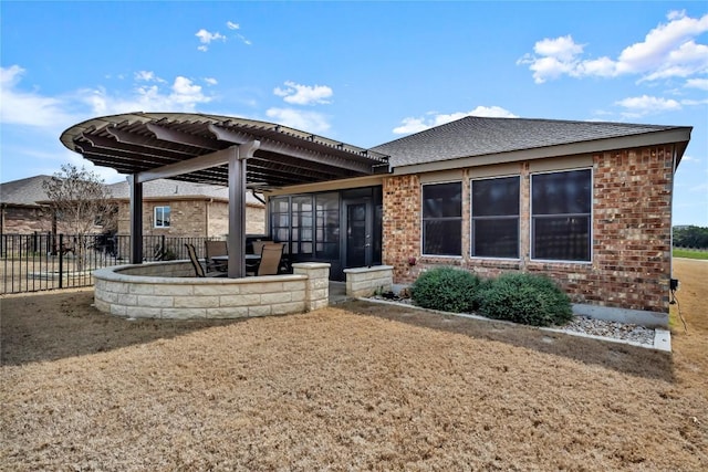 313 Brenham Pass, Georgetown, TX 78633 - rear view of house with a patio area, a shingled roof, fence, brick siding, and a sunroom