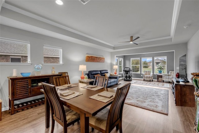 313 Brenham Pass, Georgetown, TX 78633 - dining area featuring baseboards, a ceiling fan, light wood-type flooring, and a raised ceiling