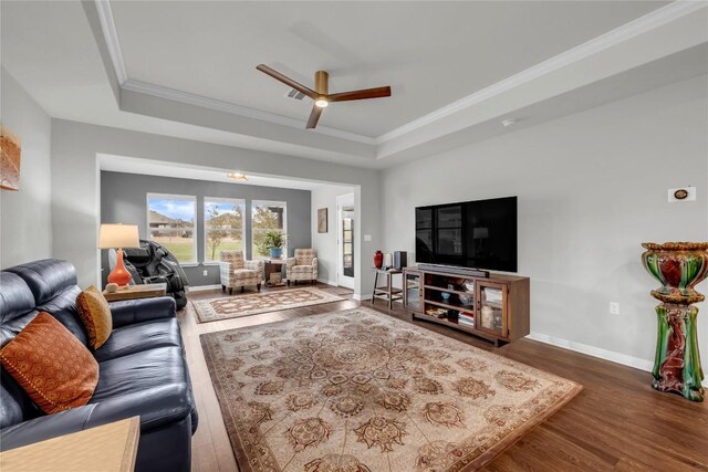313 Brenham Pass, Georgetown, TX 78633 - living room with a raised ceiling, wood finished floors, a ceiling fan, and ornamental molding