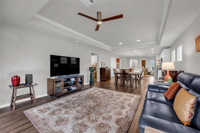313 Brenham Pass, Georgetown, TX 78633 - living area featuring wood finished floors, a ceiling fan, visible vents, and a raised ceiling