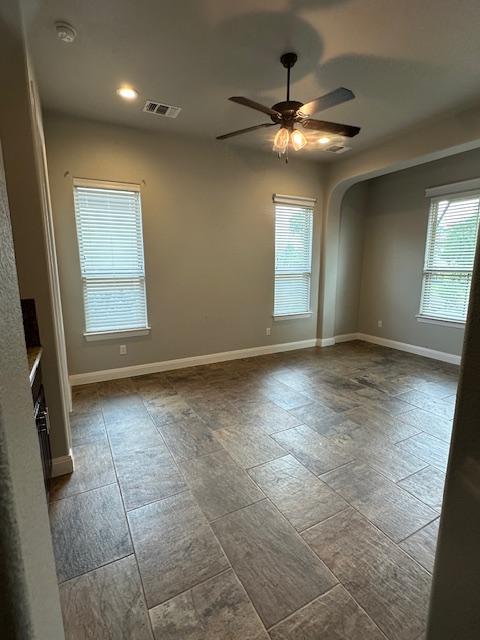 201 Grand Oaks Ln, Georgetown, TX 78628 - unfurnished room with a ceiling fan, baseboards, arched walkways, recessed lighting, and a smoke detector