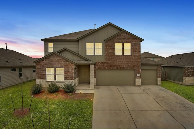 209 River Rise Rd, Kyle, TX 78640 - traditional home featuring brick siding, board and batten siding, concrete driveway, roof with shingles, and an attached garage