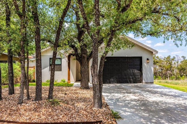 638 Oak Ln, Cottonwood Shores, TX 78657 - view of front of property with concrete driveway, stucco siding, and an attached garage