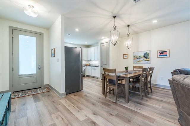 638 Oak Ln, Cottonwood Shores, TX 78657 - dining area featuring light wood finished floors, a chandelier, baseboards, and recessed lighting