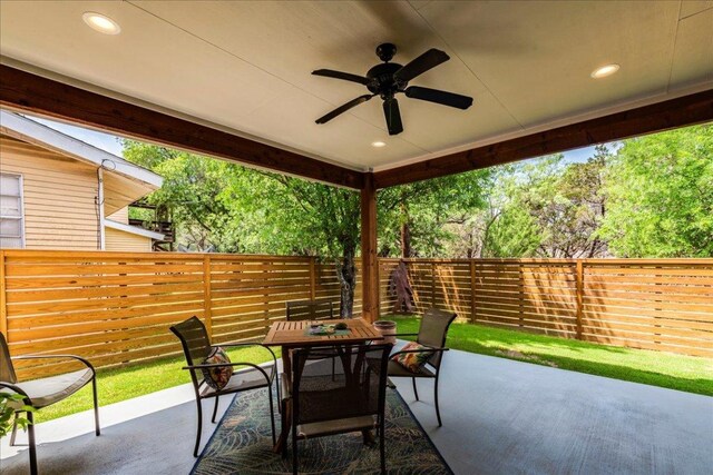 638 Oak Ln, Cottonwood Shores, TX 78657 - fenced backyard with outdoor dining space, a patio area, and a ceiling fan