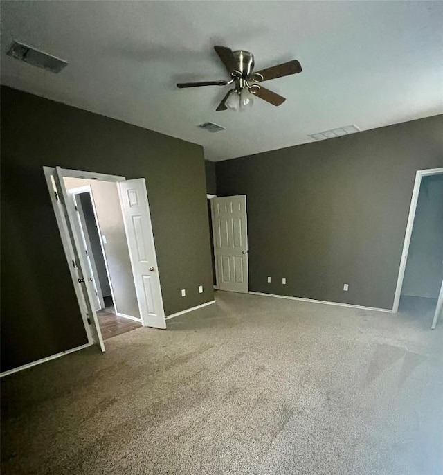 unfurnished bedroom with baseboards, visible vents, and carpet floors