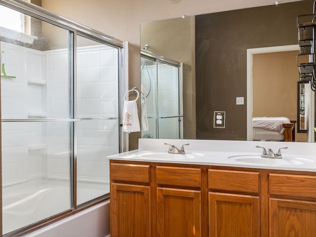 116 Brown St, Hutto, TX 78634 - full bathroom with double vanity, combined bath / shower with glass door, and a textured wall