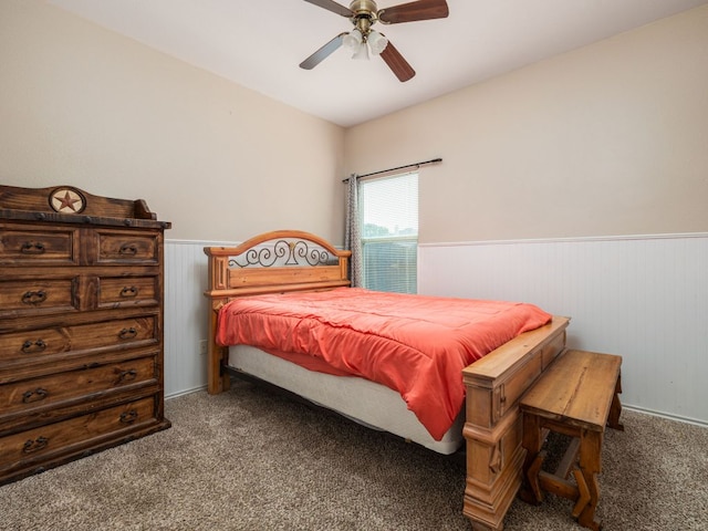 116 Brown St, Hutto, TX 78634 - bedroom with wainscoting, carpet floors, ceiling fan, and wooden walls